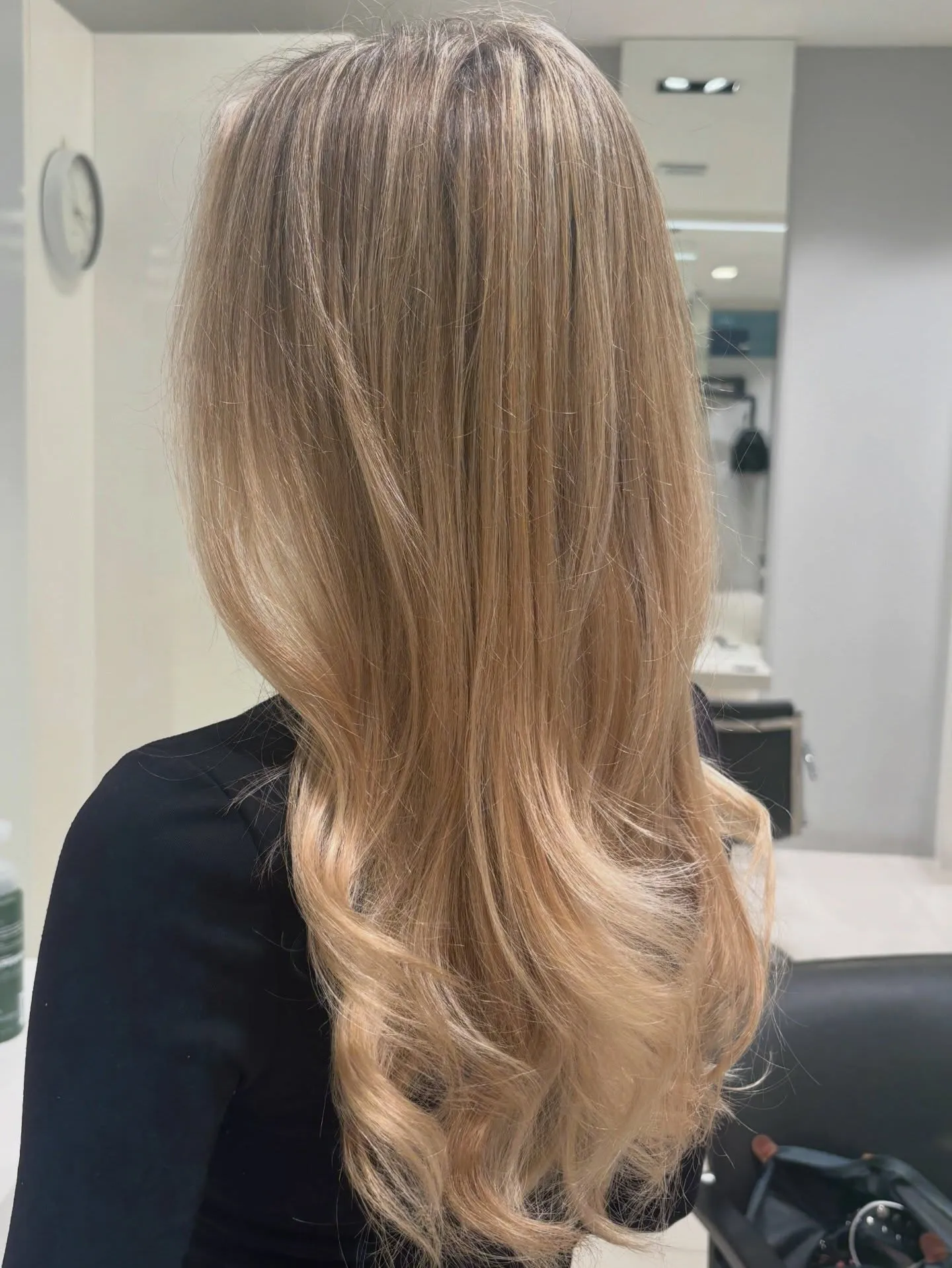 After - blended golden blonde colour transformation with soft waves, finished at Characters Hair Randwick