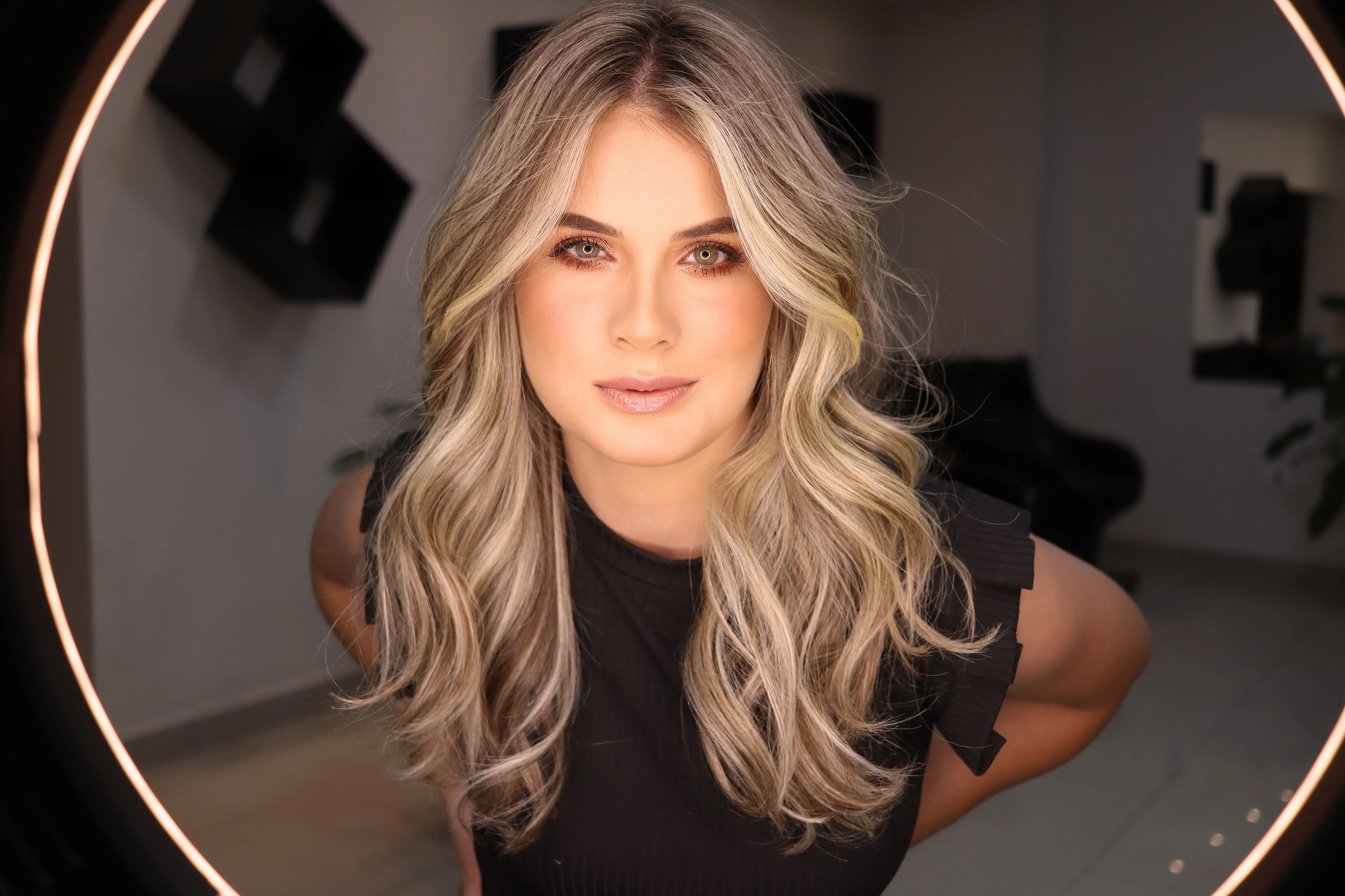 Client with long, wavy blonde hair after keratin bond hair extensions at Characters Hair, Randwick
