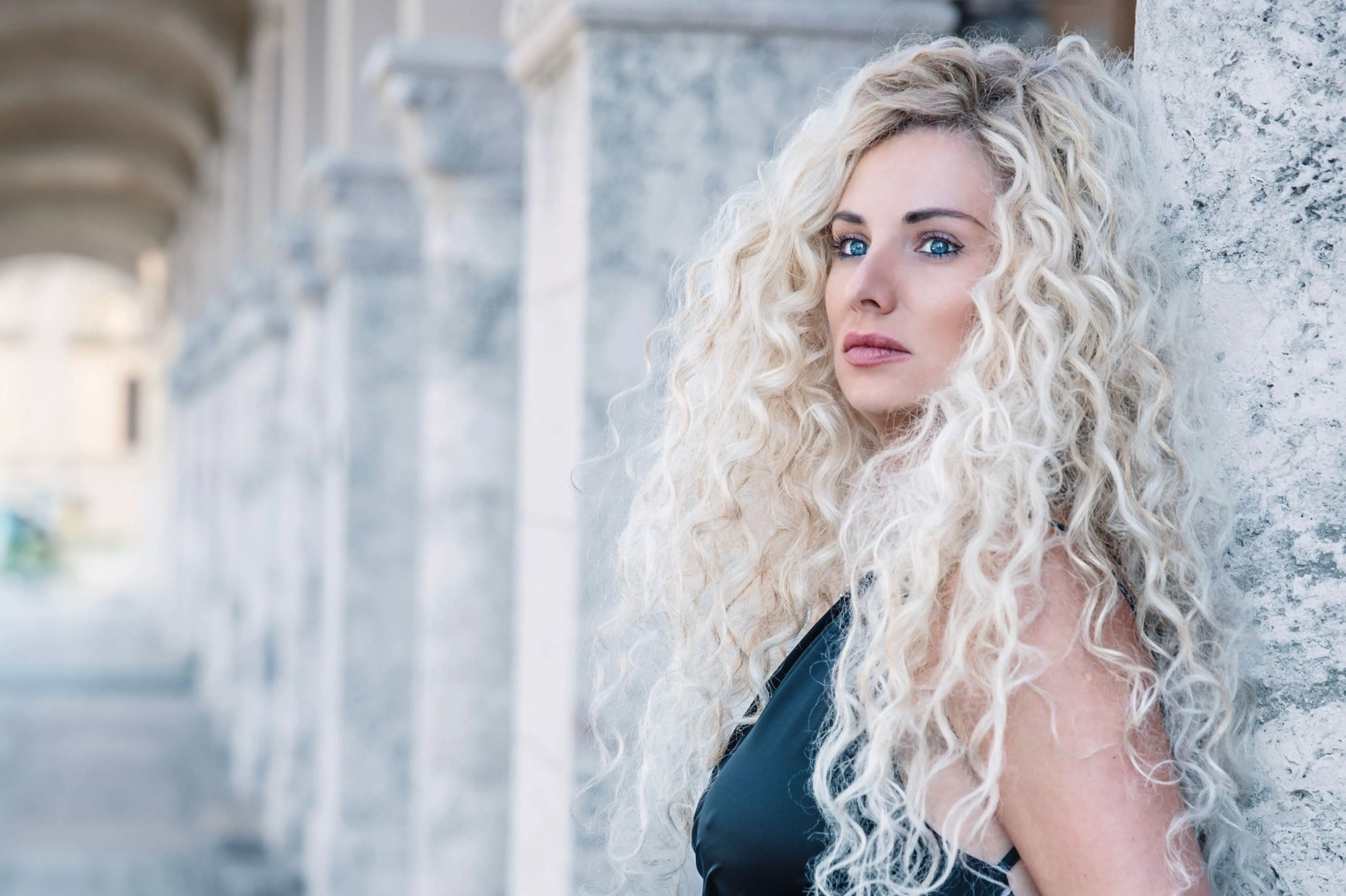 Long curly platinum blonde hair after scalp bleach and toning at Characters Hair, Randwick, Eastern Suburbs Sydney