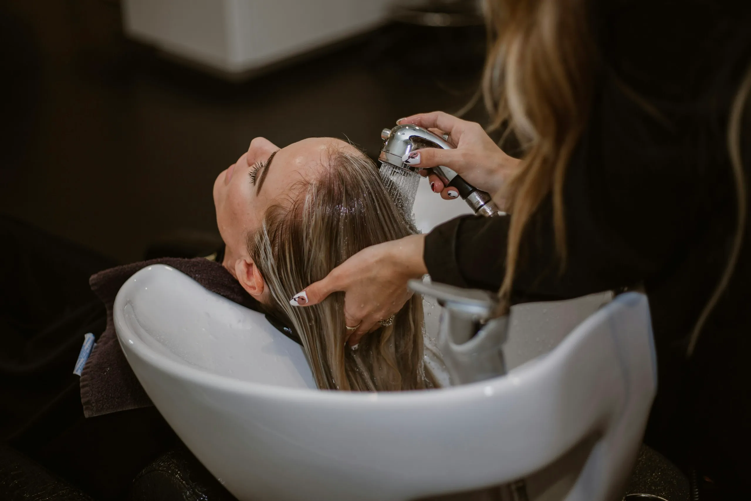 Hair being washed at the basin during a keratin smoothing treatment at Characters Hair Randwick