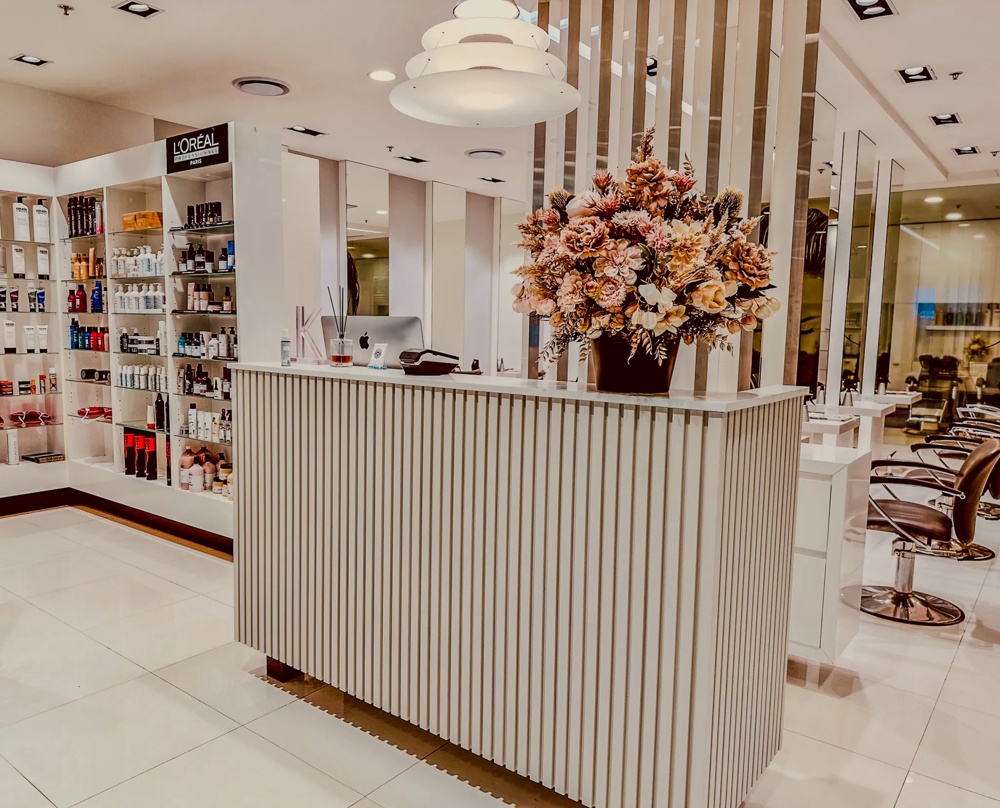 The reception desk and retail shelves inside Characters Hair salon in Randwick, Eastern Suburbs Sydney